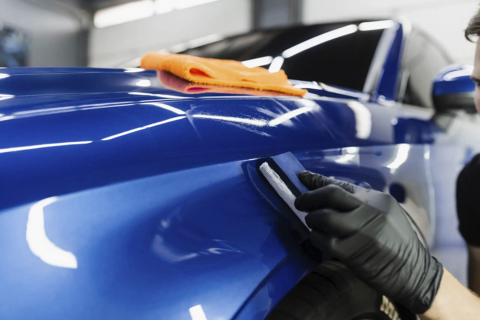 Ceramic coating application on a glossy blue car paint finish